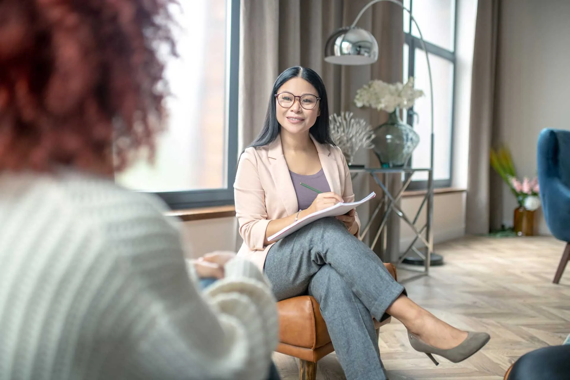 Mental Health Therapy -Therapist smiling to a patient while listening.