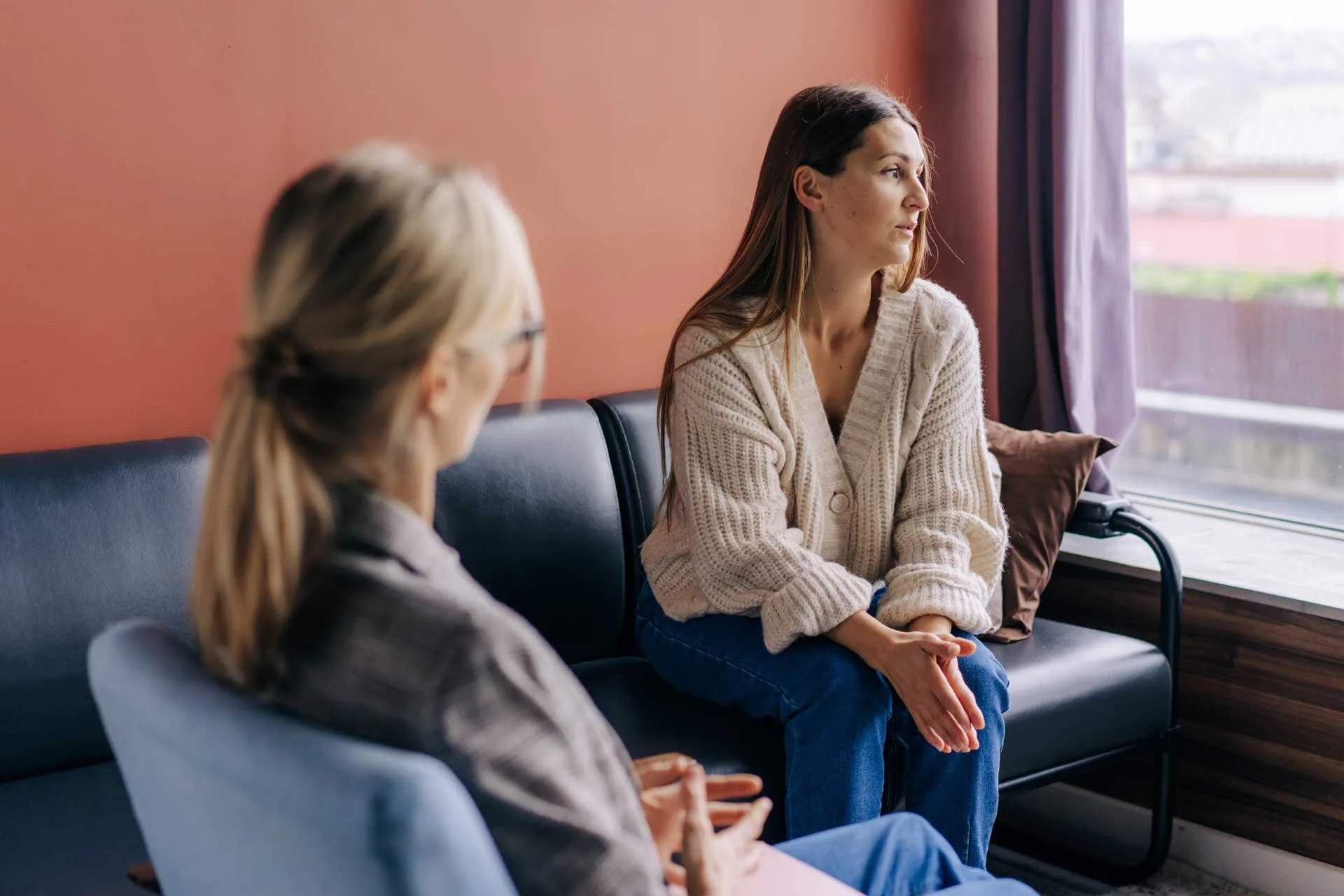 Woman speaks with a therapist during anxiety therapy.