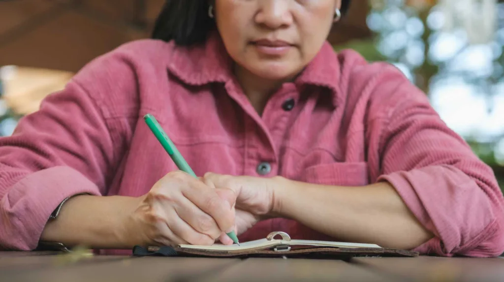 Woman writing down notes in preparation for her anxiety therapy